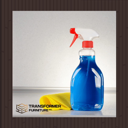 Blue cleaning spray bottle with a yellow cloth - Transformer Furniture Inc.